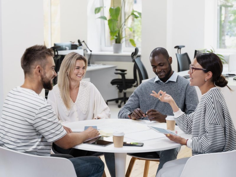 close-up-young-colleagues-having-meeting